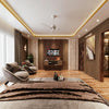 Modern bedroom with a bed, armchairs, and a television.
