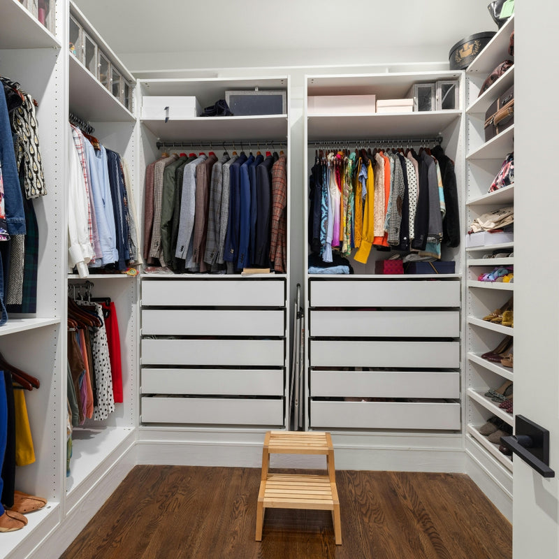 Well-organized closet with clothes, shelves, and drawers.